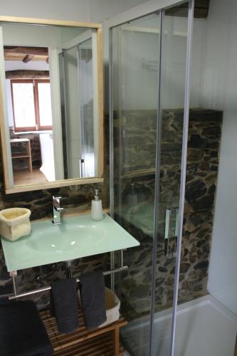 a bathroom with a sink and a shower at Cabo Do Mundo Casa Rural in Chantada