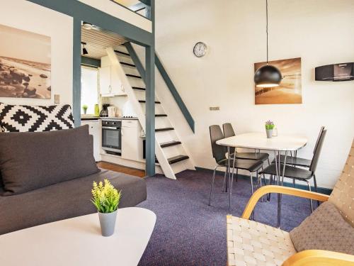 a living room with a couch and a table at 4 person holiday home in Væggerløse-By Traum in Bøtø By