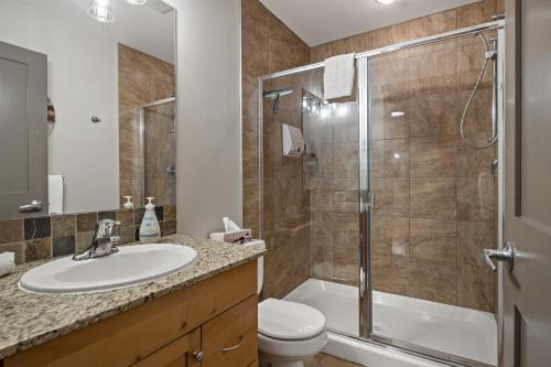 a bathroom with a shower and a sink and a toilet at RidgeView Loft - Top Floor 2 Bed 2 Bath, Amazing Views in Canmore