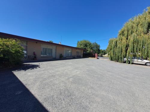 an empty parking lot in front of a building at Great Western Motel in Great Western