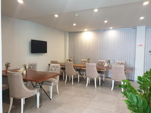 a conference room with tables and chairs and a tv at Ballantine hotel in Ho Chi Minh City