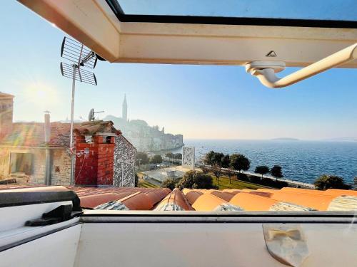 a view of the ocean from a window at Loreto LYA SEA VIEW APARTMENTS in Rovinj