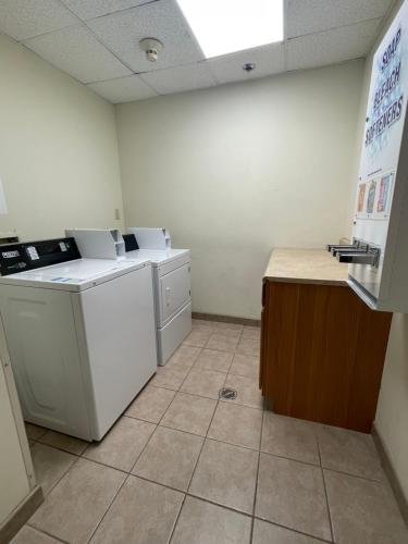 a laundry room with white appliances and a counter at Comfort Inn Pinehurst - Southern Pines in Pinehurst