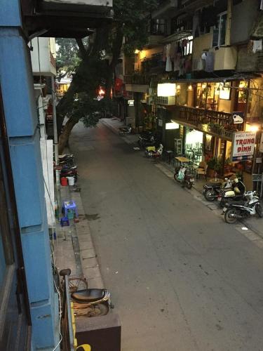 an empty street in a city at night at MayHouse Travel in Hanoi