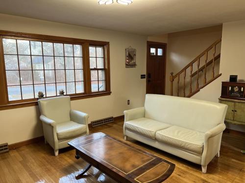 a living room with a couch and a coffee table at A charm Cape house centrally located close to everything that Cape code offers in Yarmouth