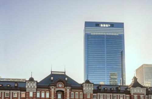 a large building in front of a tall skyscraper at Bulgari Hotel Tokyo in Tokyo