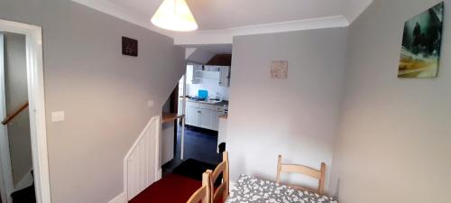 a room with a kitchen and a dining room at Penzance Cottage in Penzance