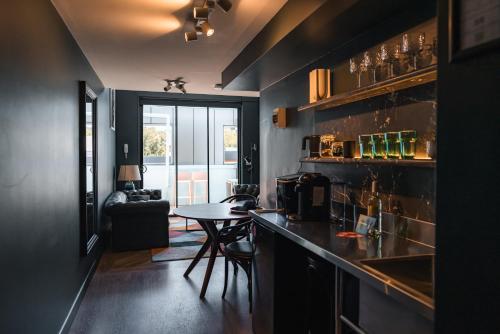 a kitchen with a counter and a table in a room at The Blue Hotel Bondi in Sydney
