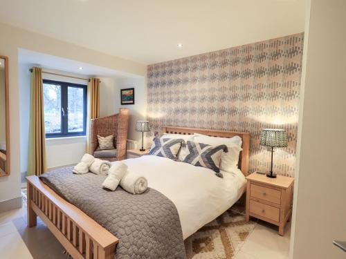 a bedroom with a large bed with towels on it at Riverside Park 2 in Keswick