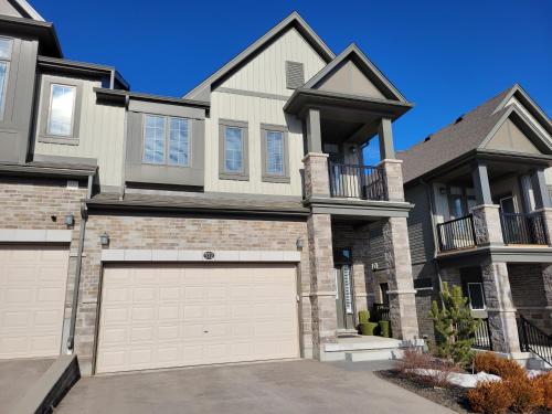 a large house with a garage at Exclusive Townhome near West-Side Trails in Waterloo