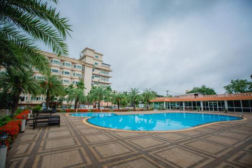 um resort com uma piscina em frente a um edifício em Siamgrand Hotel em Udon Thani