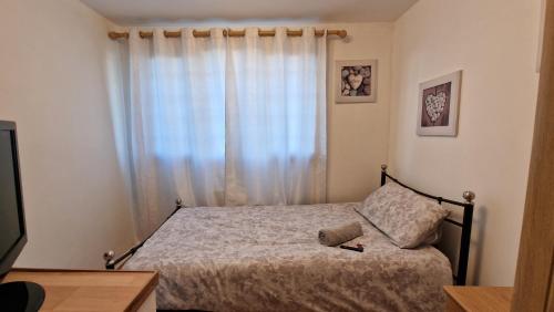 a bedroom with a bed and a window at Shergold House in Swindon