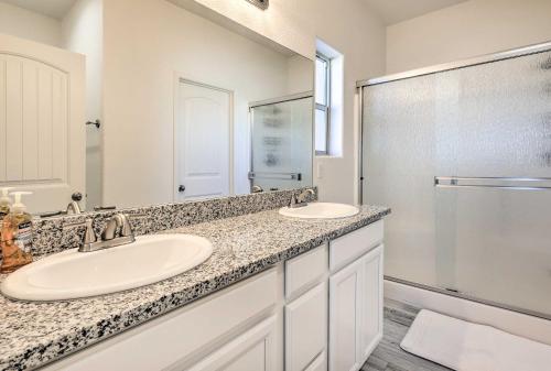 a bathroom with two sinks and a shower at Modern Kingman Vacation Rental, 5 Mi to Dtwn! in Kingman
