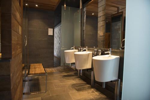 a row of white urinals in a bathroom at Enjoy Santiago in Los Andes