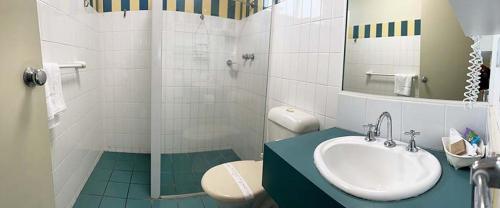 a bathroom with a sink and a toilet and a shower at Waterview Apartments in Port Macquarie