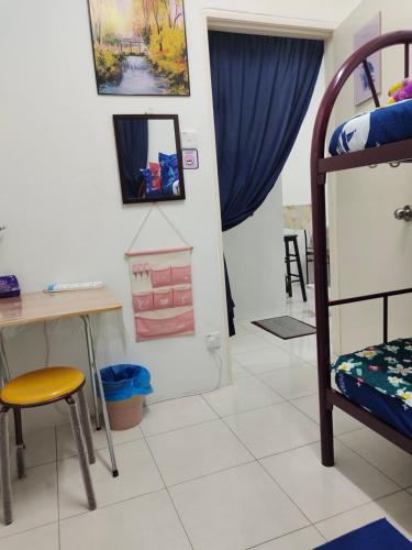 a room with a desk and a bunk bed at UNIE HOMESTAY in Wakaf Che Yeh
