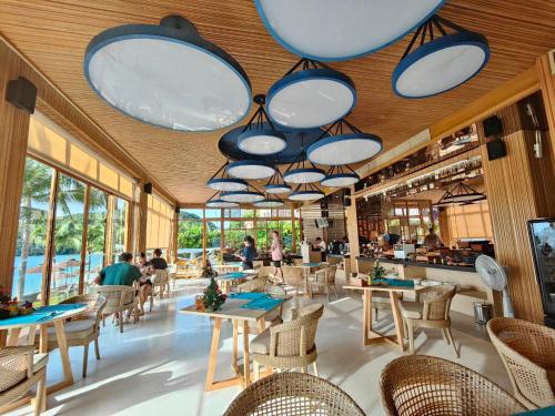 a restaurant with tables and chairs and large lights at Bandara Pool Villas, Phuket in Panwa Beach
