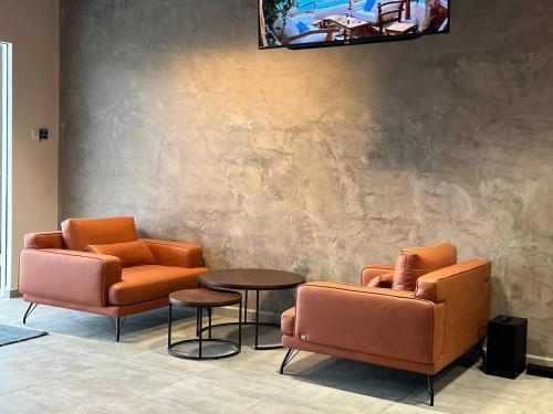 two chairs and a table in a waiting room at ALL IN HOTEL in Kangar