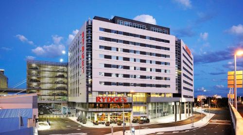 a large white building with a riegels sign on it at Rydges Sydney Airport Hotel in Sydney