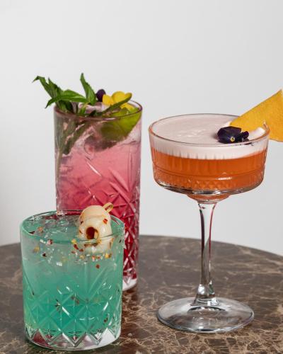 two glasses of different colored liquids on a table at Rydges Sydney Airport Hotel in Sydney