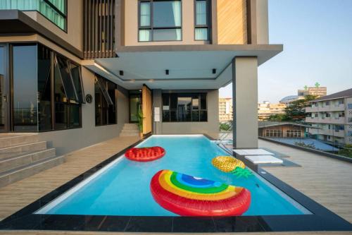 a swimming pool in the middle of a house at Increase hotel & residence in Samutprakarn
