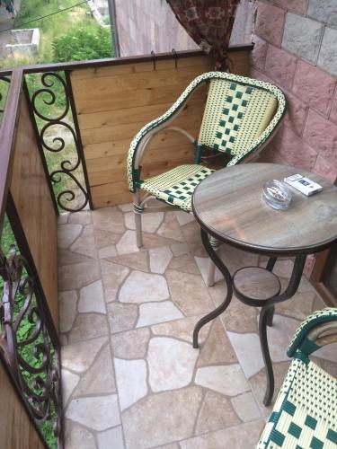 a patio with a table and chairs on a patio at DILIJAN Apartment in Dilijan