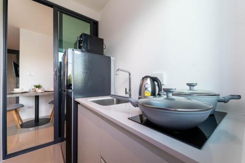 a kitchen with a bowl on a counter next to a refrigerator at Central Hill View A901 A in Kathu