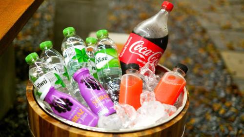 a bucket filled with soda and ice and soda bottles at The Wild Khao Yai in Klang Dong