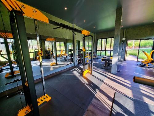 an empty gym with a gym with benches and machines at The Wild Khao Yai in Klang Dong