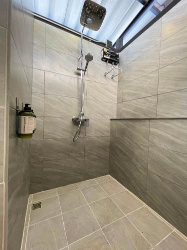 a bathroom with a shower with a shower at The Wild Khao Yai in Klang Dong
