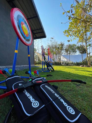 a golf bag sitting on the grass next to a target at The Wild Khao Yai in Klang Dong