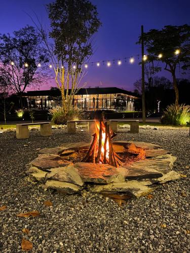 a fire pit in a park at night at The Wild Khao Yai in Klang Dong