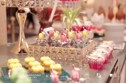 a buffet of cupcakes and muffins on a table at Shangri-La Wuhan,Close to The Mixc with three subway lines in Wuhan