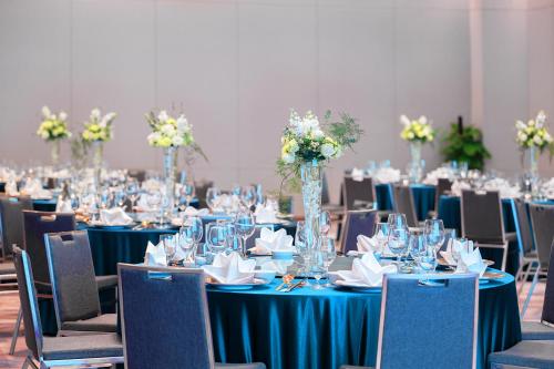 a room full of tables with blue table cloth and chairs at Shangri-La Wuhan,Close to The Mixc with three subway lines in Wuhan