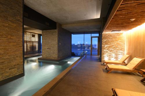 a lobby with chairs and a view of the city at Enjoy Chiloé in Castro