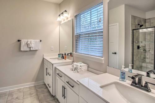 a bathroom with two sinks and a large mirror at N Myrtle Beach Townhome Near Barefoot Resort! in North Myrtle Beach