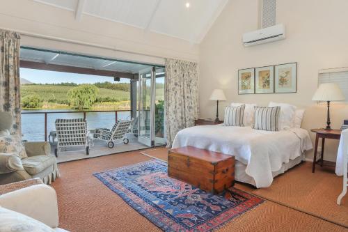 a bedroom with a bed and a view of the water at Elgin Country Cottage in Elgin