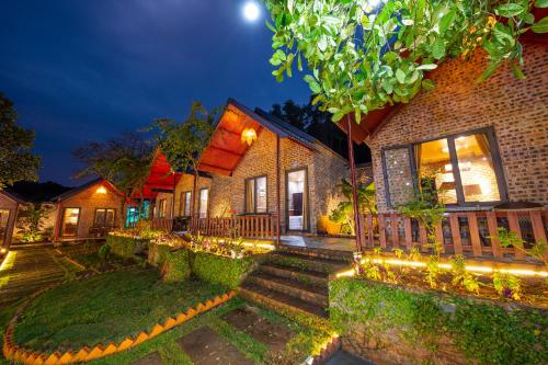 a house with lights on the front of it at Cat Ba Spring Garden Homestay in Cat Ba