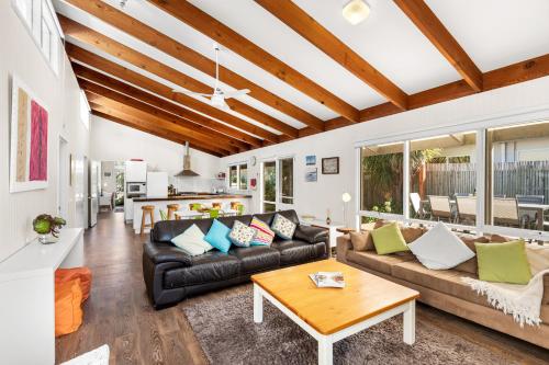 a living room with a couch and a table at Point Lonsdale Beach House - Relax Beach Surf Golf in Point Lonsdale