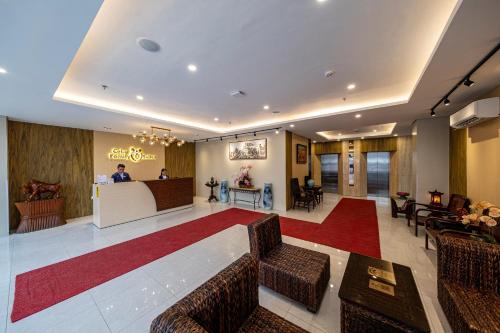 a lobby of a hotel with chairs and a bar at Cebu Family Suites powered by Cocotel in Cebu City