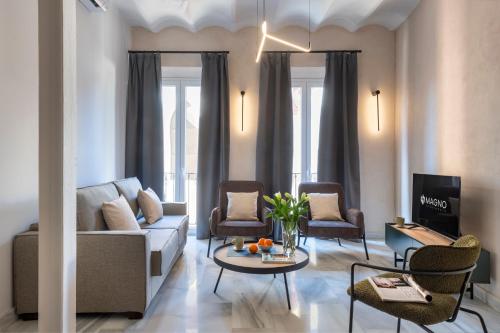 a living room with a couch and chairs at Magno Apartments San Gil - Shared Jacuzzi in Seville