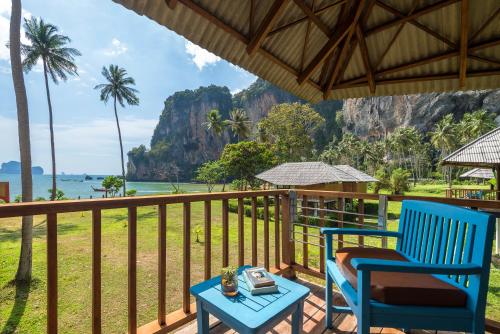 a porch with two blue chairs and a table at Tinidee Hideaway Tonsai Beach Krabi - SHA Extra Plus in Tonsai Beach