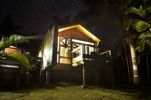 a cabin at night with the lights on at Betikure Parc Lodge in Bourail