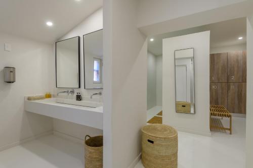 a white bathroom with a sink and mirrors at San Lameer Villa 3704 - 2 Bedroom Superior - 4 pax -San Lameer Rental Agency in Southbroom