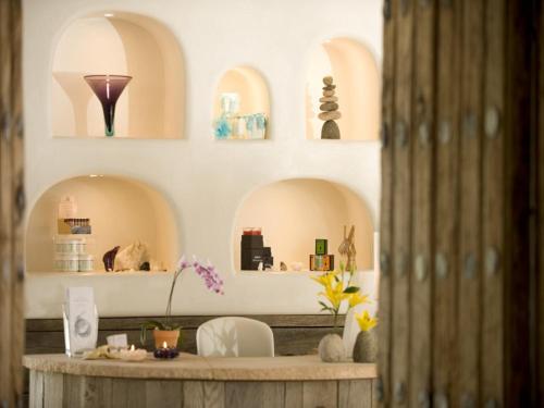 a room with arches and a table with flowers at The Hacienda & Spa in Santa Fe