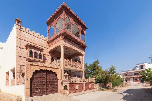 an old building with a large wooden door on a street at Sunset Escape by VEO - Part of StayVista in Jodhpur