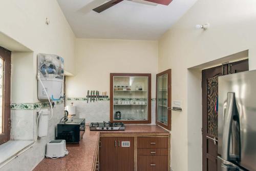 a kitchen with a sink and a refrigerator at Sunset Escape by VEO - Part of StayVista in Jodhpur