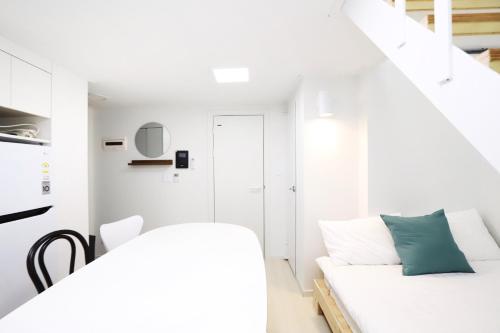 a white room with a white couch and a table at Apartment J garden Myeongdong Station in Seoul