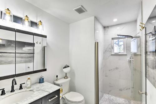 a bathroom with a shower and a toilet and a sink at Florida Getaway with Patio about 3 Mi to Beaches! in New Smyrna Beach