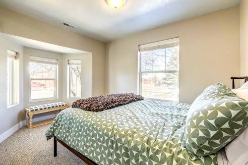 a bedroom with a bed and two windows at Mountain-View Cedar City Home with Large Yard! in Cedar City